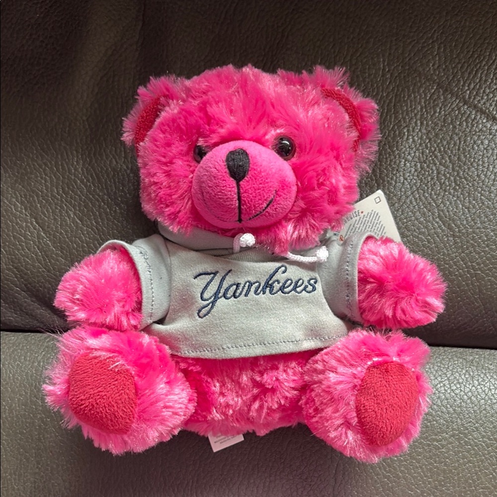 New York Yankees pink stuffed teddy bear in gray shirt